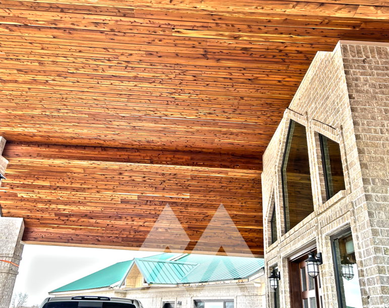 Warm cedar tongue and groove ceiling crafted from Eastern Red Cedar lumber, paired with a sleek ceiling fan in a contemporary outdoor setting